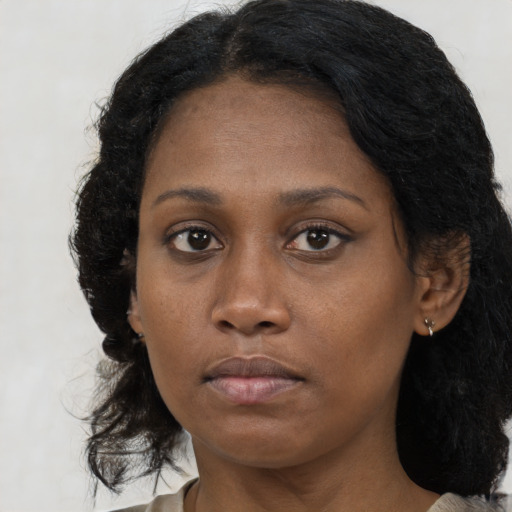 Neutral black young-adult female with medium  brown hair and brown eyes