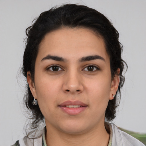 Joyful white young-adult female with medium  black hair and brown eyes