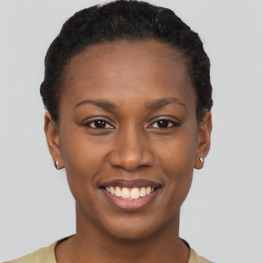 Joyful black young-adult female with short  brown hair and brown eyes
