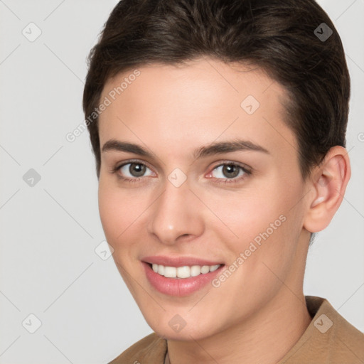 Joyful white young-adult female with short  brown hair and brown eyes