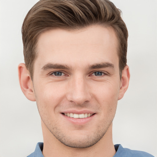 Joyful white young-adult male with short  brown hair and grey eyes