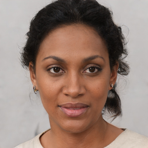 Joyful black young-adult female with short  brown hair and brown eyes
