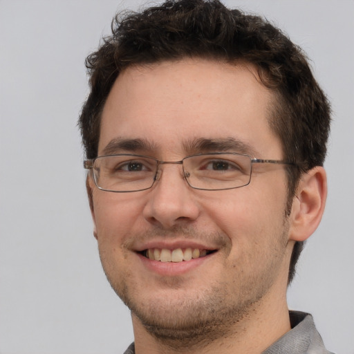 Joyful white adult male with short  brown hair and brown eyes