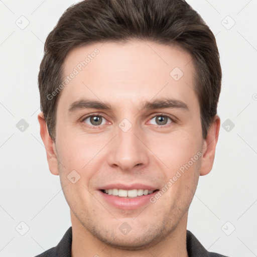 Joyful white young-adult male with short  brown hair and grey eyes