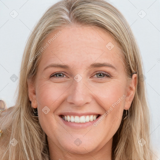 Joyful white young-adult female with long  brown hair and blue eyes