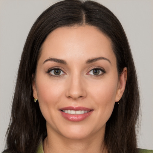 Joyful white young-adult female with long  brown hair and brown eyes