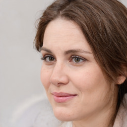 Joyful white adult female with medium  brown hair and grey eyes