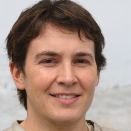 Joyful white adult male with short  brown hair and brown eyes