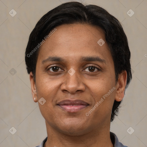 Joyful black adult female with short  brown hair and brown eyes