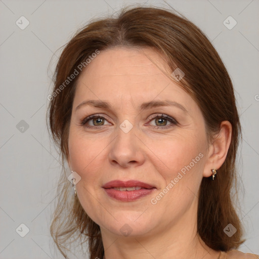 Joyful white adult female with medium  brown hair and grey eyes