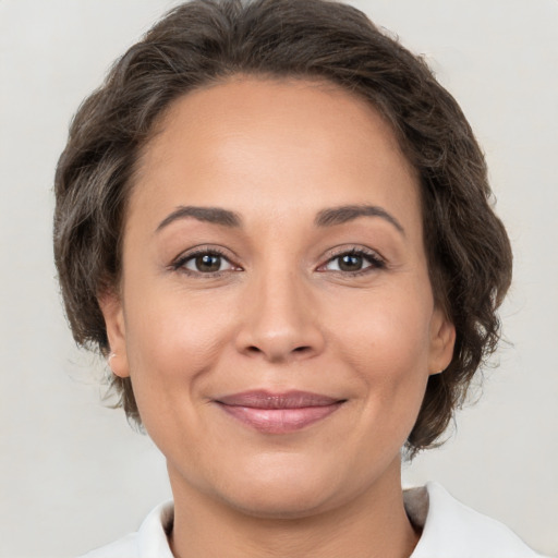 Joyful white adult female with medium  brown hair and brown eyes