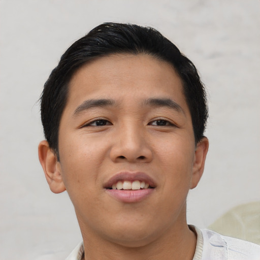 Joyful asian young-adult male with short  brown hair and brown eyes