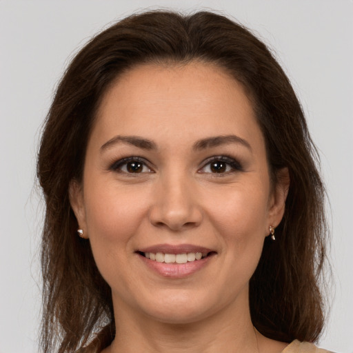 Joyful white young-adult female with long  brown hair and brown eyes