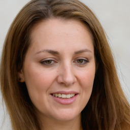 Joyful white young-adult female with long  brown hair and green eyes