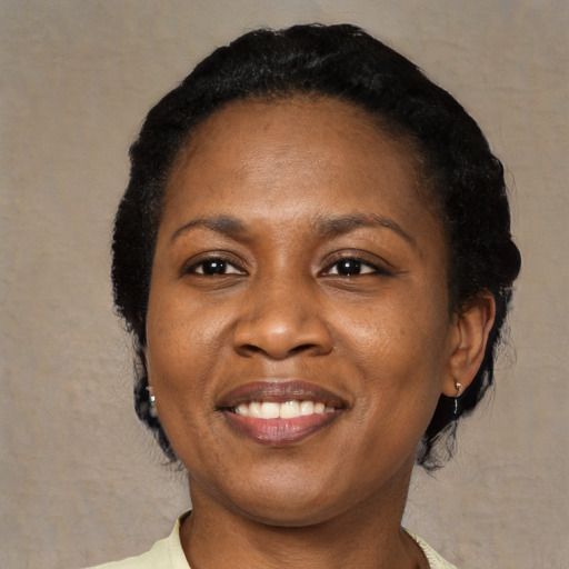 Joyful black adult female with short  black hair and brown eyes