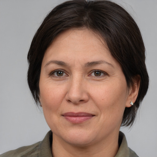 Joyful white adult female with medium  brown hair and brown eyes