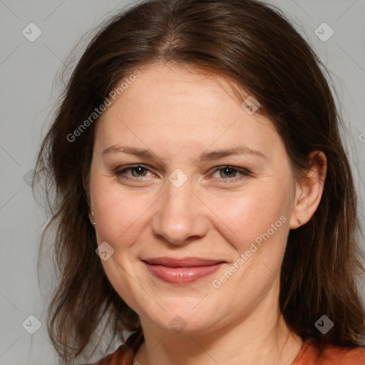 Joyful white adult female with medium  brown hair and brown eyes