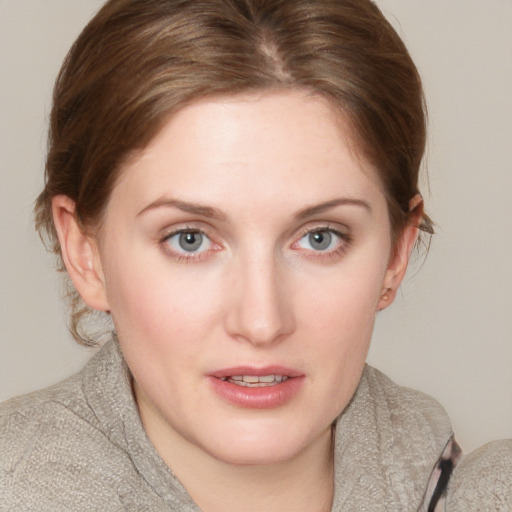 Joyful white young-adult female with short  brown hair and blue eyes