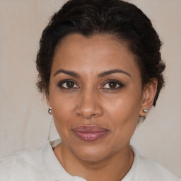 Joyful black adult female with medium  brown hair and brown eyes