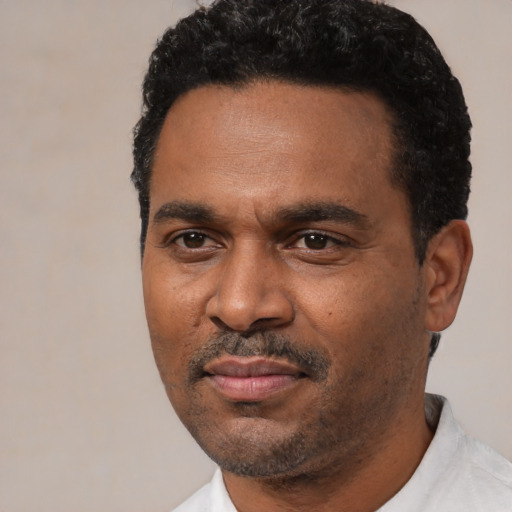 Neutral latino adult male with short  black hair and brown eyes