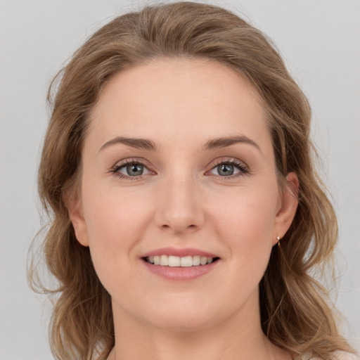 Joyful white young-adult female with medium  brown hair and green eyes