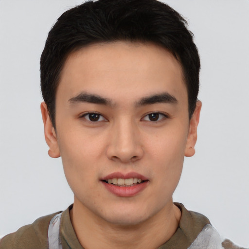 Joyful asian young-adult male with short  brown hair and brown eyes