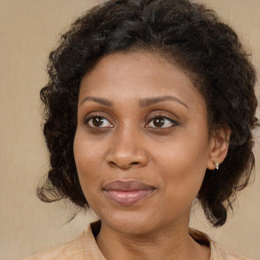 Joyful black young-adult female with medium  brown hair and brown eyes