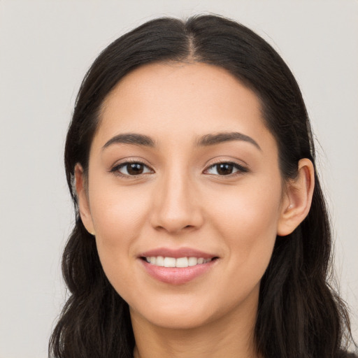 Joyful white young-adult female with long  brown hair and brown eyes