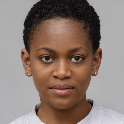 Joyful black child female with short  brown hair and brown eyes