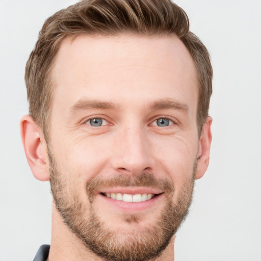 Joyful white young-adult male with short  brown hair and grey eyes