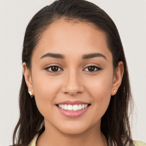 Joyful white young-adult female with long  brown hair and brown eyes