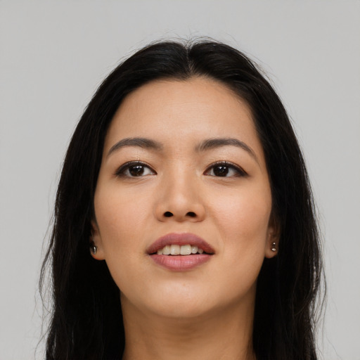 Joyful asian young-adult female with long  black hair and brown eyes