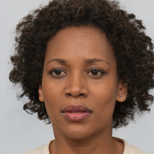 Joyful black adult female with short  brown hair and brown eyes