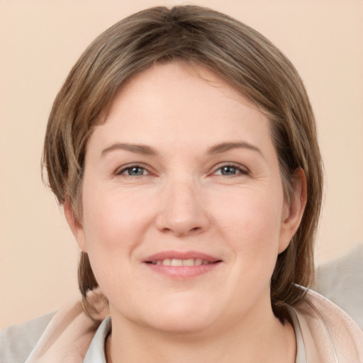 Joyful white young-adult female with medium  brown hair and grey eyes