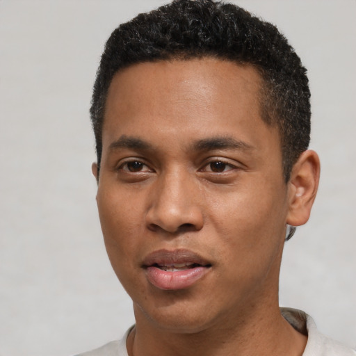 Joyful black young-adult male with short  black hair and brown eyes