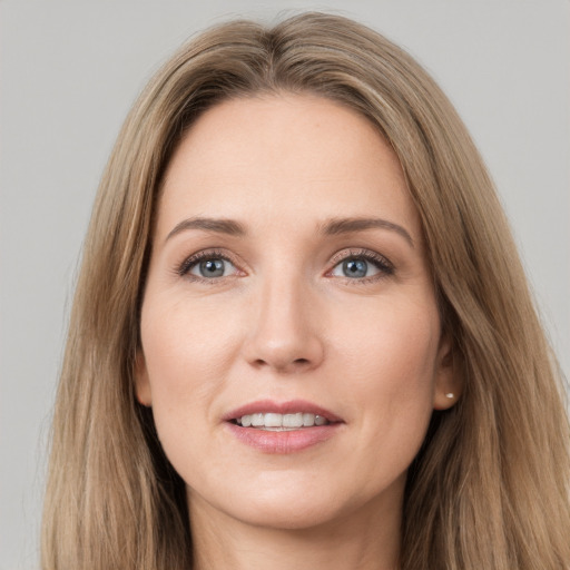 Joyful white young-adult female with long  brown hair and grey eyes