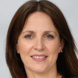 Joyful white adult female with long  brown hair and grey eyes