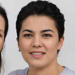 Joyful asian young-adult female with short  brown hair and brown eyes