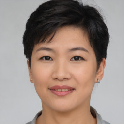 Joyful asian young-adult female with short  brown hair and brown eyes