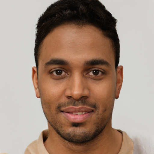 Joyful latino young-adult male with short  brown hair and brown eyes
