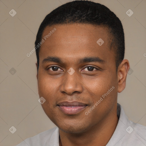 Joyful black young-adult male with short  black hair and brown eyes