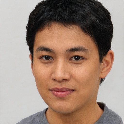 Joyful asian young-adult male with short  black hair and brown eyes