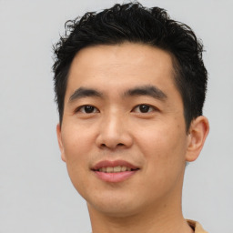 Joyful asian young-adult male with short  brown hair and brown eyes