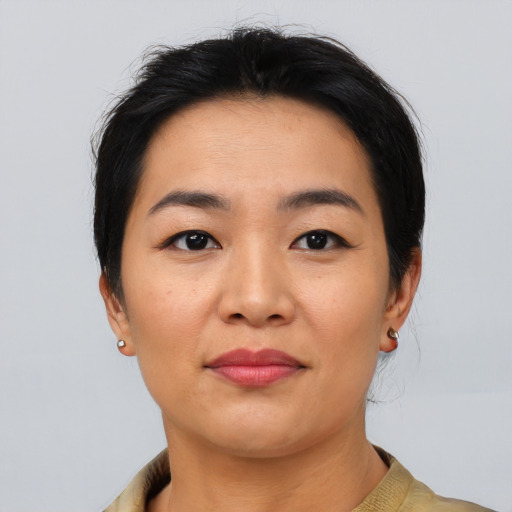 Joyful asian young-adult female with short  black hair and brown eyes