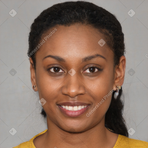 Joyful black young-adult female with short  black hair and brown eyes