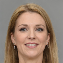 Joyful white adult female with long  brown hair and grey eyes