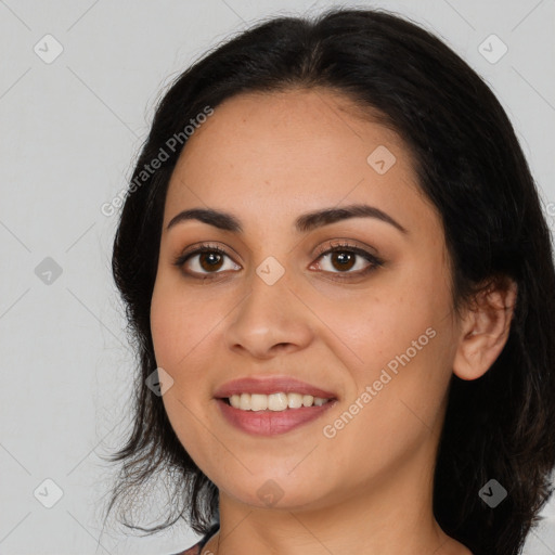 Joyful latino young-adult female with long  brown hair and brown eyes