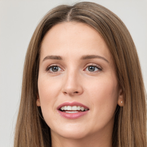 Joyful white young-adult female with long  brown hair and brown eyes