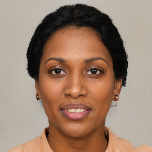 Joyful black young-adult female with short  black hair and brown eyes