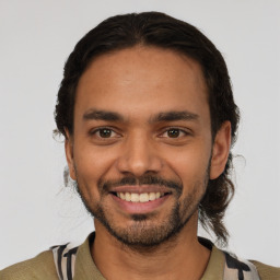 Joyful latino young-adult male with short  black hair and brown eyes